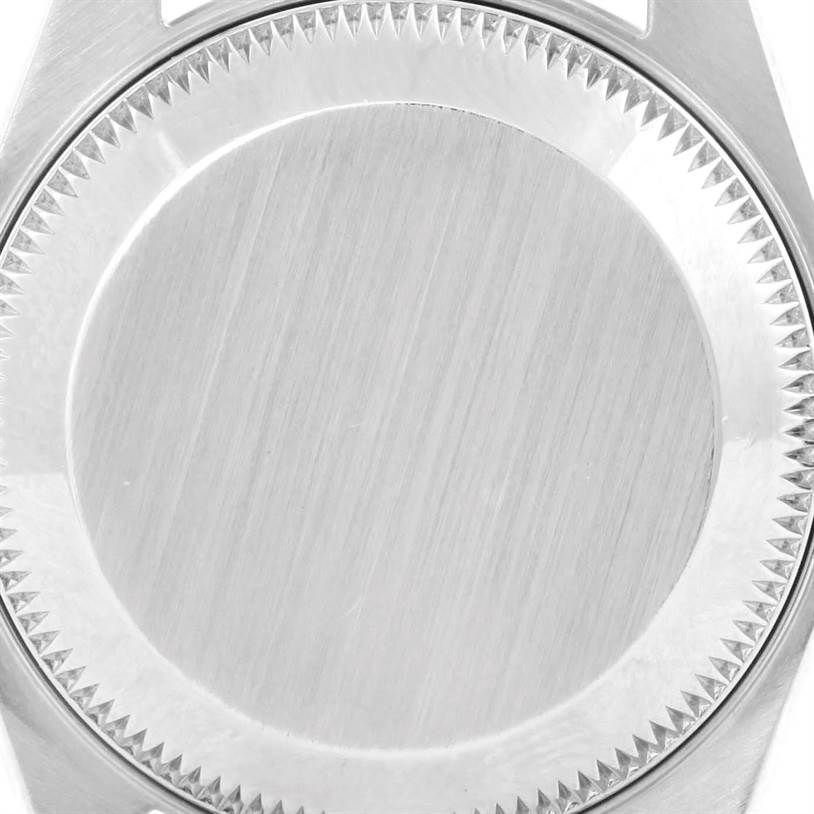 This image shows the case back and part of the bezel of a Rolex Datejust 79174 Women's Stainless Steel Black Dial 79174 Women's Stainless Steel Black Dial watch from a close-up angle.