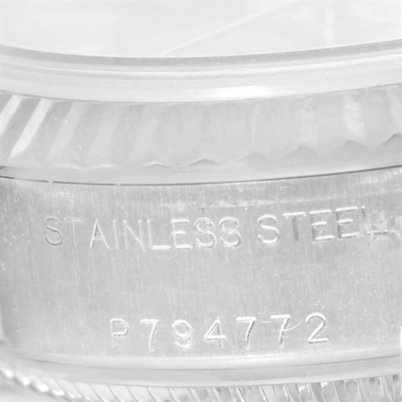 The image shows a close-up side angle of the case of a Rolex Datejust 79174 Women's Stainless Steel Black Dial 79174 Women's Stainless Steel Black Dial, highlighting the stainless steel material and serial number.