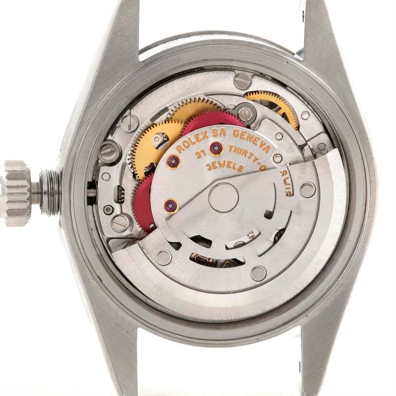 This image shows the internal mechanism of a Rolex Datejust 79174 Women
s Stainless Steel Blue Dial 79174 Women
s Stainless Steel Blue Dial watch with gears and components visible from the back.