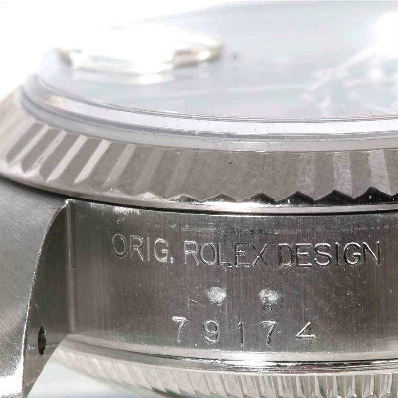 The close-up image shows the side engraving and fluted bezel of a Rolex Datejust 79174 Women
s Stainless Steel Blue Dial 79174 Women
s Stainless Steel Blue Dial watch.
