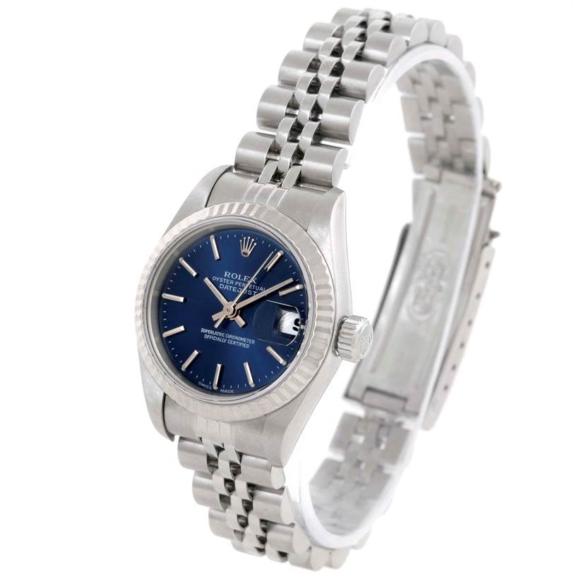 This Rolex Datejust 79174 Women
s Stainless Steel Blue Dial 79174 Women
s Stainless Steel Blue Dial watch is shown at an angled view, displaying its blue dial, fluted bezel, and Jubilee stainless steel bracelet.