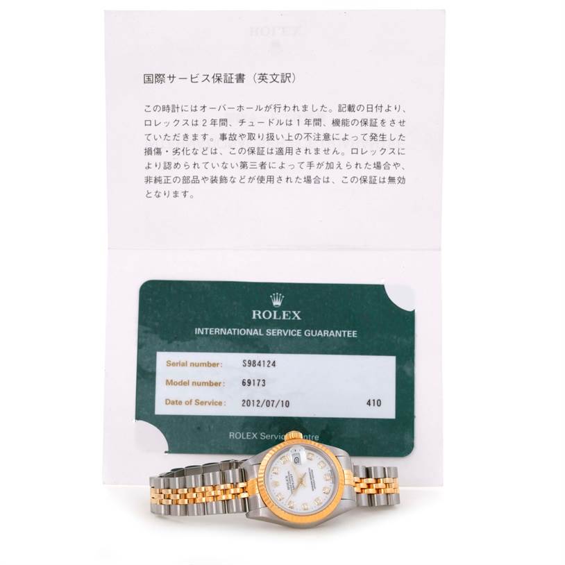 The image shows a Rolex Datejust 69173 Women's Stainless Steel White Dial 69173 Women's Stainless Steel White Dial watch laid flat, with its certificate of authenticity and service guarantee card.