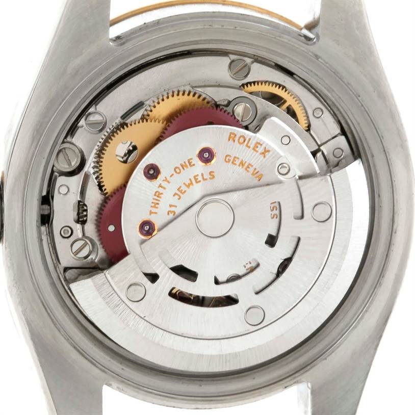 This image shows the internal movement mechanism of a Rolex Datejust 179173 Women's Steel and Gold (two tone) Champagne Dial 179173 Women's Steel and Gold (two tone) Champagne Dial watch from a back angle, featuring gears and other components.