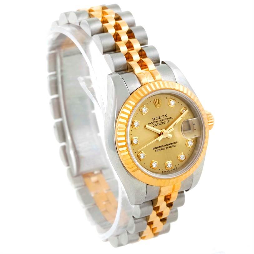 The image shows a Rolex Datejust 179173 Women's Steel and Gold (two tone) Champagne Dial 179173 Women's Steel and Gold (two tone) Champagne Dial watch at a three-quarter angle, highlighting the two-tone bracelet, fluted bezel, and champagne diamond dial.