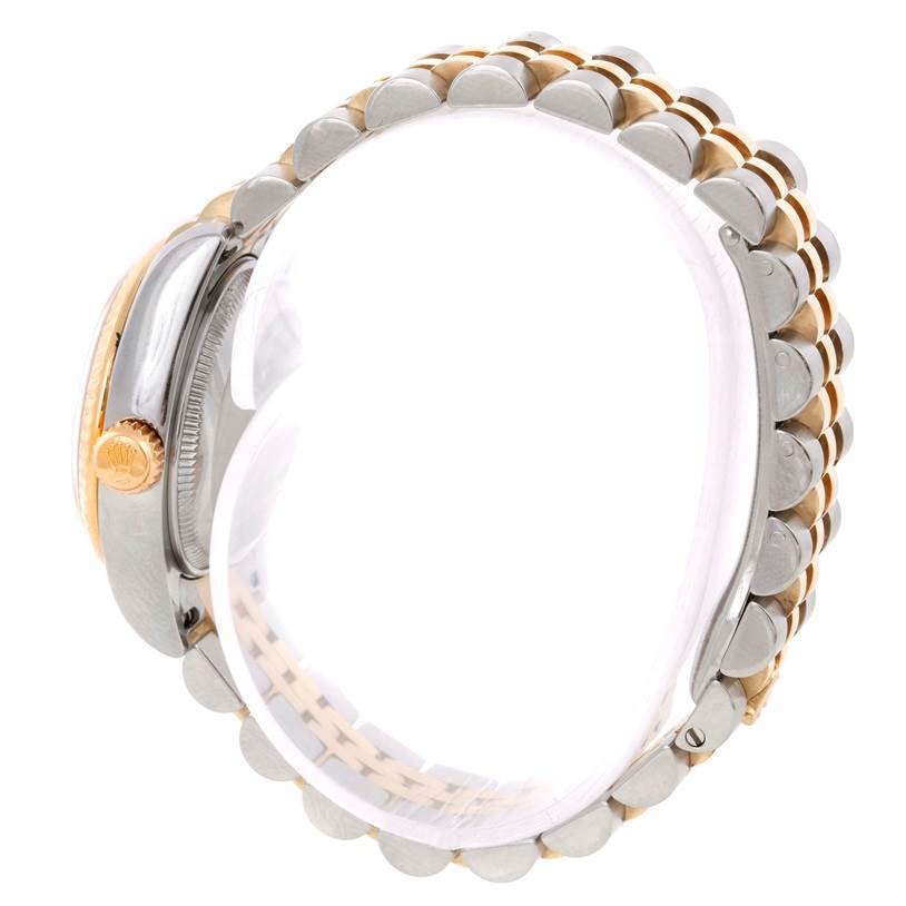 The image shows the side view of a Rolex Datejust 179173 Women's Steel and Gold (two tone) Champagne Dial 179173 Women's Steel and Gold (two tone) Champagne Dial watch, highlighting its crown and jubilee bracelet.