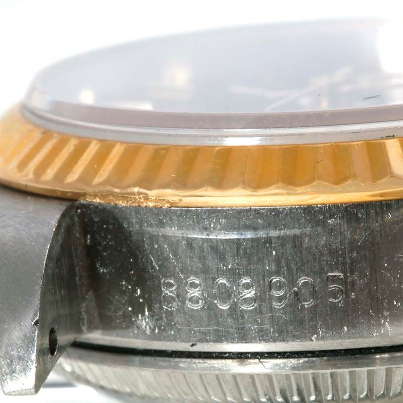 This image shows a close-up of the Rolex Datejust 69173 Women's Stainless Steel Black Dial 69173 Women's Stainless Steel Black Dial watch case, focusing on the bezel and case with visible serial numbers.