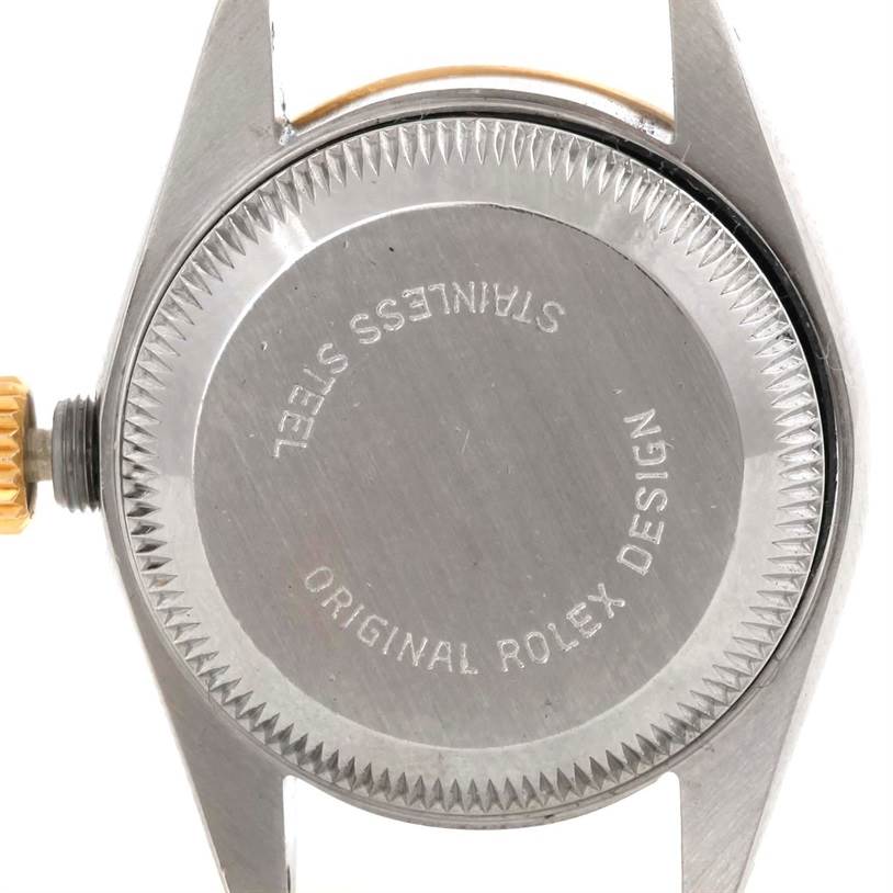The image shows the back case of a Rolex Datejust 69173 Women's Stainless Steel Black Dial 69173 Women's Stainless Steel Black Dial watch, highlighting the crown and engravings.