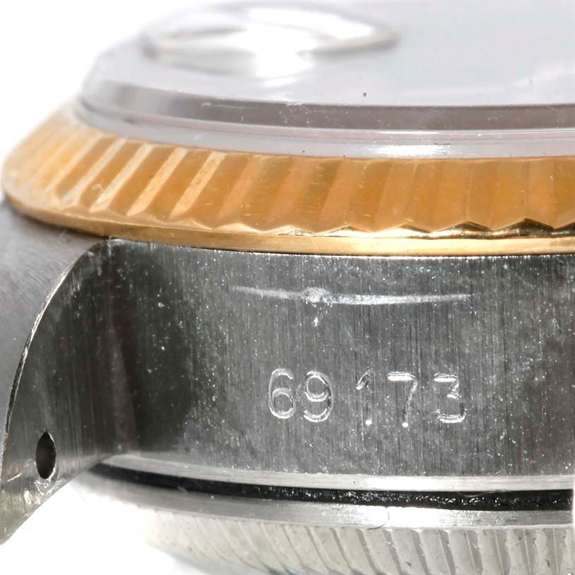 This image shows a close-up of the side case, bezel, and serial number of a Rolex Datejust 69173 Women's Stainless Steel Black Dial 69173 Women's Stainless Steel Black Dial watch.