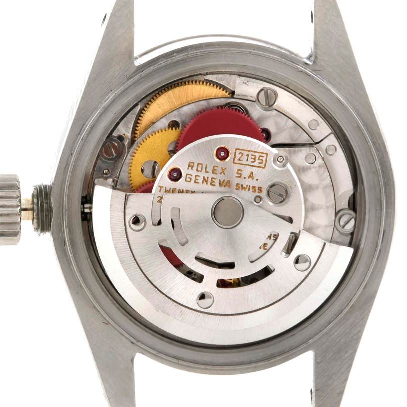 The image displays the movement and inner workings of a Rolex Datejust 69174 Women's Stainless Steel Silver Dial 69174 Women's Stainless Steel Silver Dial watch from the back, showcasing gears and the winding mechanism.