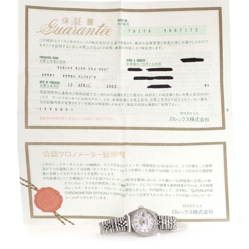 The Rolex Datejust 79174 Women's Stainless Steel Silver Dial 79174 Women's Stainless Steel Silver Dial watch is displayed from the front, positioned on a certificate of guarantee.