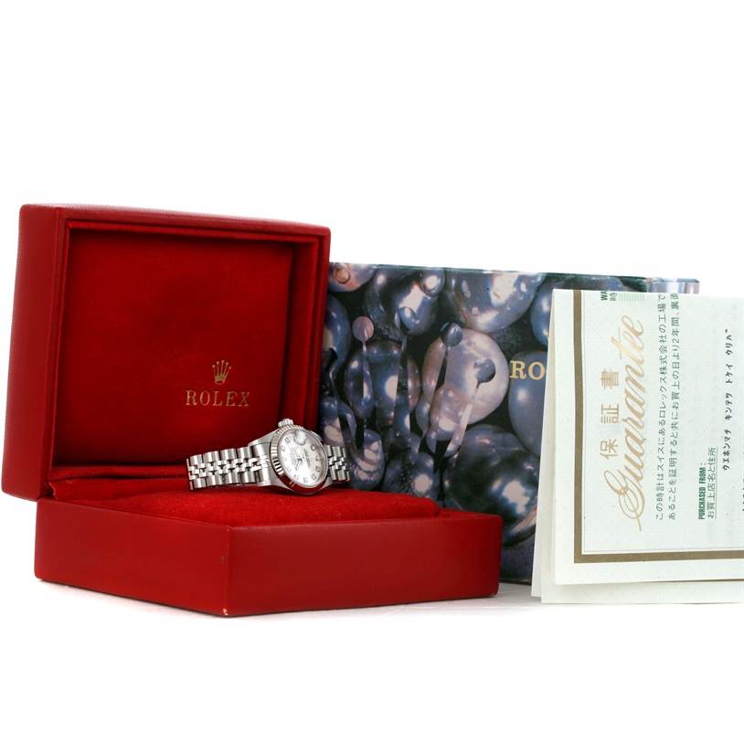 This image shows a Rolex Datejust 79174 Women's Stainless Steel Silver Dial 79174 Women's Stainless Steel Silver Dial watch in a red Rolex box, along with its papers and outer box.
