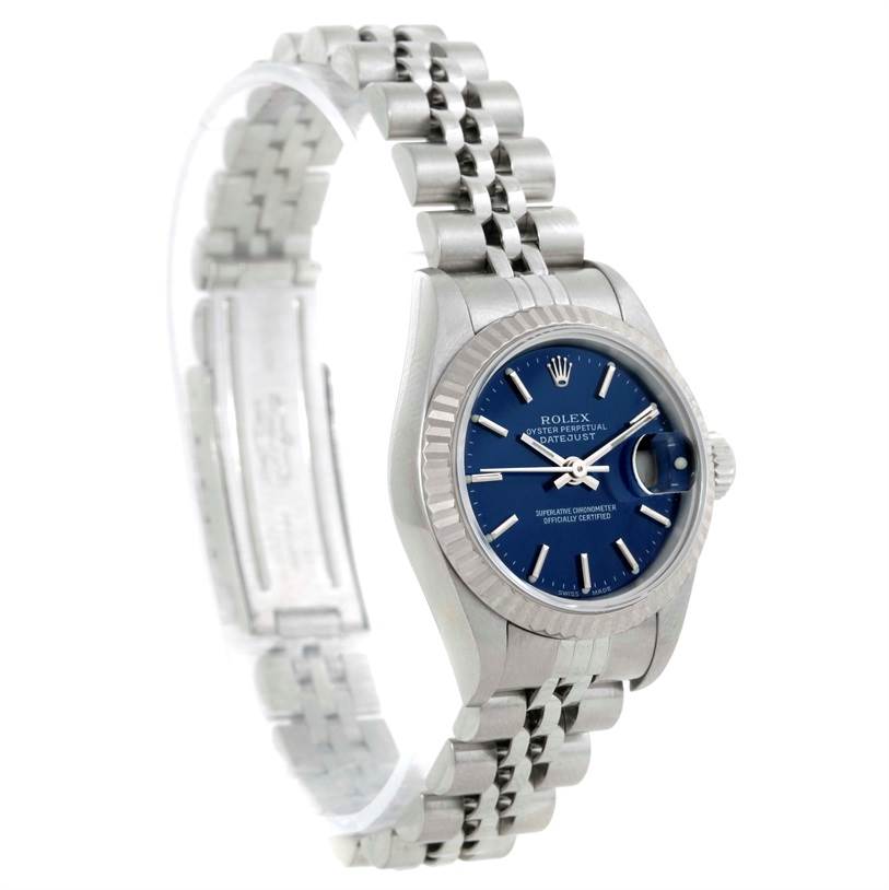 The Rolex Datejust 79174 Women's Stainless Steel Blue Dial 79174 Women's Stainless Steel Blue Dial watch is shown at a three-quarter angle, displaying its jubilee bracelet, fluted bezel, blue dial, and date window.