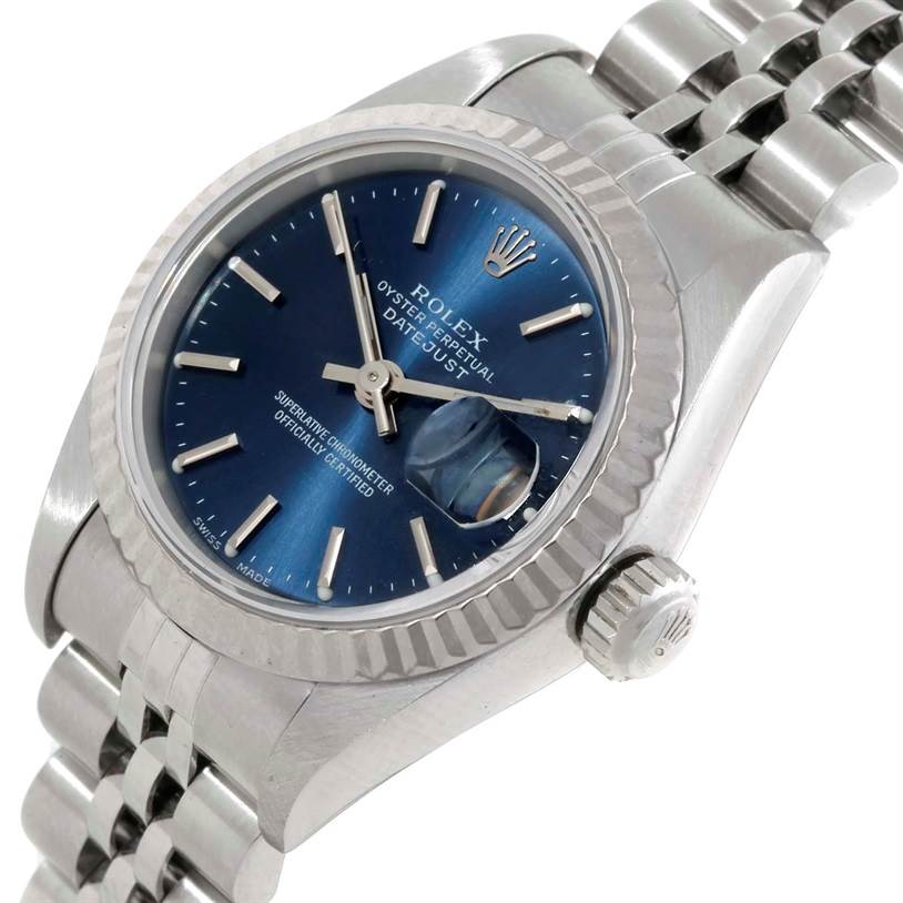 The image shows a Rolex Datejust 79174 Women's Stainless Steel Blue Dial 79174 Women's Stainless Steel Blue Dial watch at a diagonal angle, highlighting its blue dial, fluted bezel, crown, and jubilee bracelet.