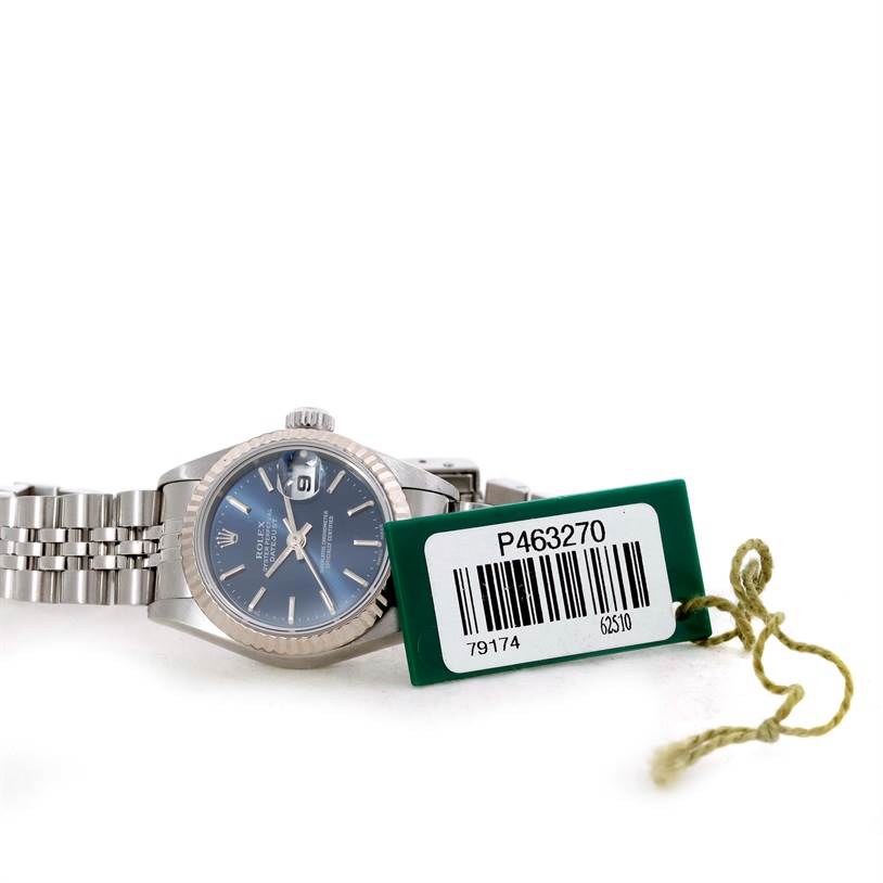 The Rolex Datejust 79174 Women's Stainless Steel Blue Dial 79174 Women's Stainless Steel Blue Dial watch is shown from a slightly angled front view, accompanied by its green barcode tag.
