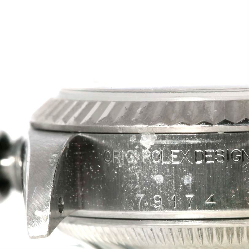 The image shows a close-up angle of the side of a Rolex Datejust 79174 Women's Stainless Steel Pink Dial 79174 Women's Stainless Steel Pink Dial model, featuring part of the case and bezel.