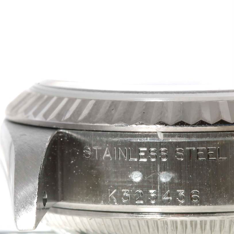 This close-up image shows the side profile of a Rolex Datejust 79174 Women's Stainless Steel Pink Dial 79174 Women's Stainless Steel Pink Dial watch case, highlighting its stainless steel engraving and serial number.