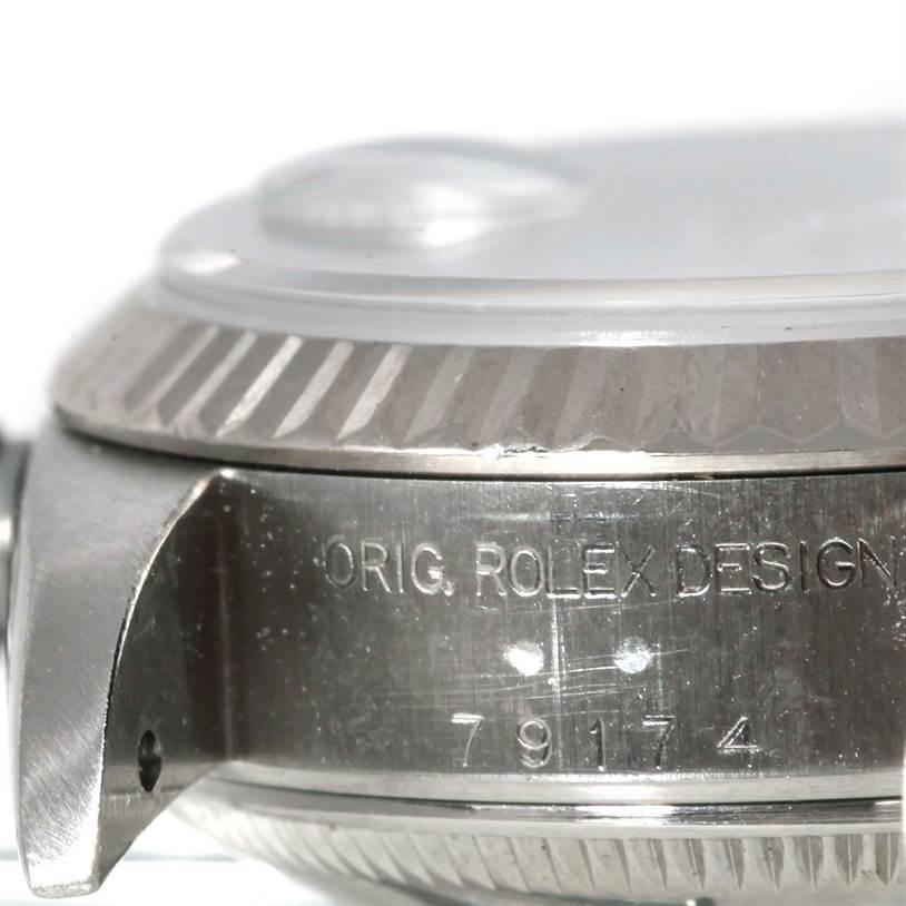 The image shows a close-up angle of the side of a Rolex Datejust 79174 Women's Stainless Steel Silver Dial 79174 Women's Stainless Steel Silver Dial watch, focusing on the case and the engraved model number 79174.