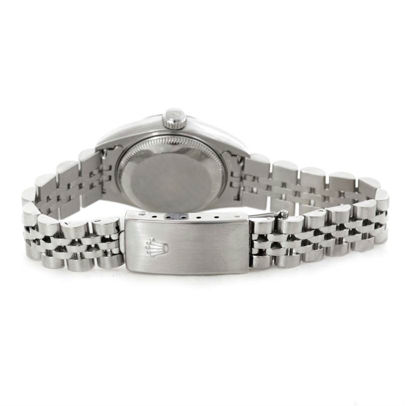 The image shows the back of the Rolex Datejust 79174 Women's Stainless Steel Silver Dial 79174 Women's Stainless Steel Silver Dial watch, particularly the case back and the clasp of the bracelet.