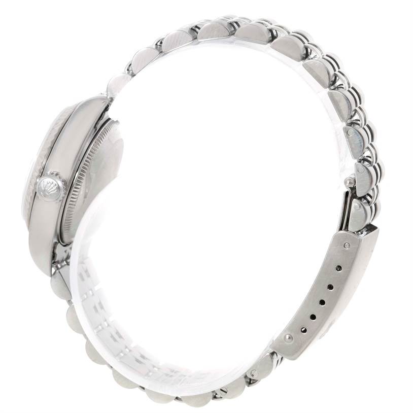 The image shows a Rolex Datejust 79174 Women's Stainless Steel Silver Dial 79174 Women's Stainless Steel Silver Dial watch from a side angle, highlighting its case, crown, and metal bracelet.