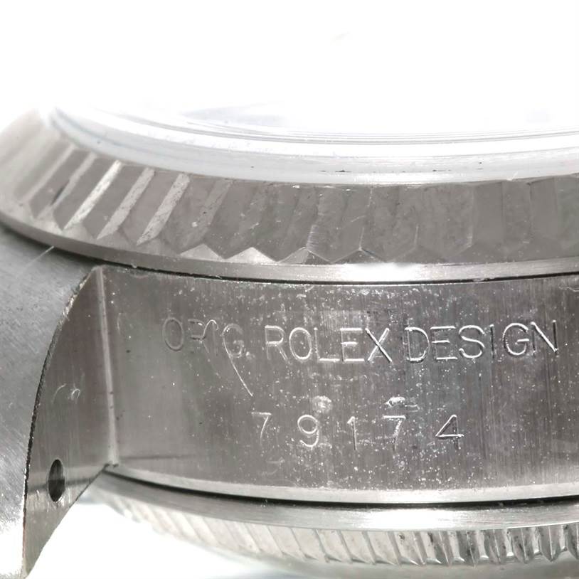 This close-up shows the side of the Rolex Datejust 79174 Women's Stainless Steel Silver Dial 79174 Women's Stainless Steel Silver Dial watch case, displaying the engraving and part of the bezel.