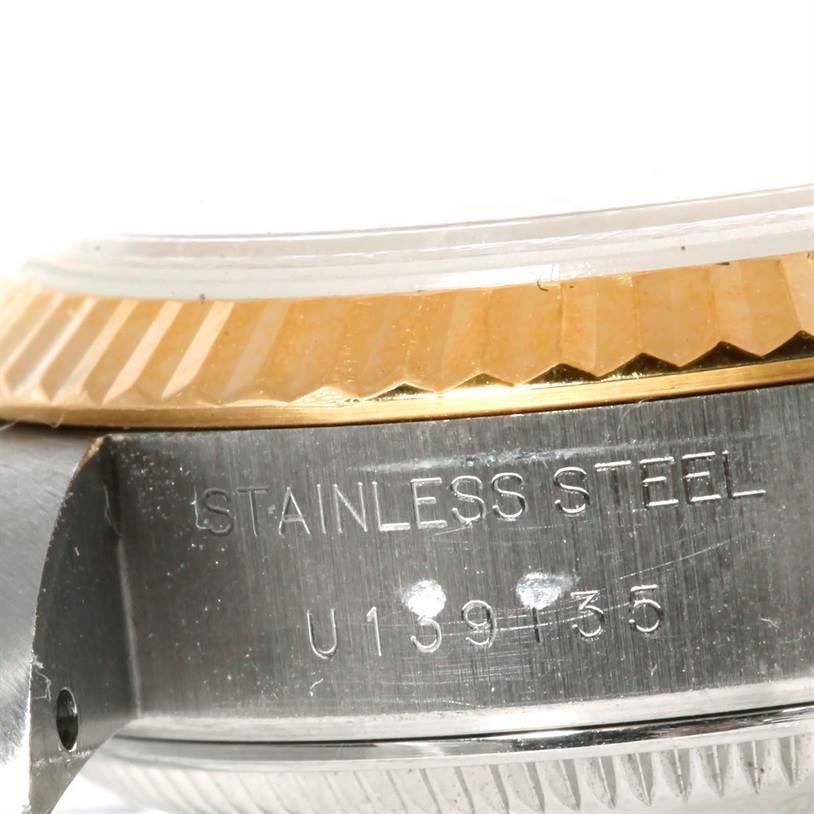 The image shows a close-up of the side of a Rolex Datejust 69173 Women's Stainless Steel Champagne Dial 69173 Women's Stainless Steel Champagne Dial watch, focusing on the stainless steel case and part of the bezel.
