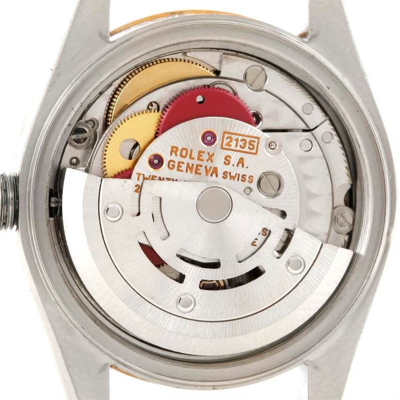 The image shows the movement mechanism of a Rolex Datejust 69173 Women's Stainless Steel Champagne Dial 69173 Women's Stainless Steel Champagne Dial watch viewed from the back, revealing gears and the rotor.