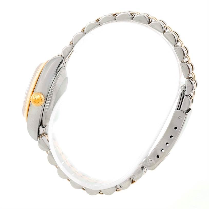 This side view of the Rolex Datejust 69173 Women's Stainless Steel Champagne Dial 69173 Women's Stainless Steel Champagne Dial watch highlights its crown, case, and partial bracelet.