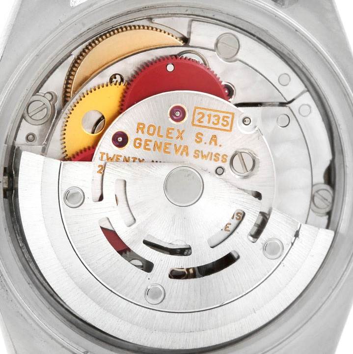 The image shows the inner mechanism of a Rolex Datejust 69173 Women's Stainless Steel Beige Dial 69173 Women's Stainless Steel Beige Dial watch, viewed from the back, highlighting gears and inscriptions.
