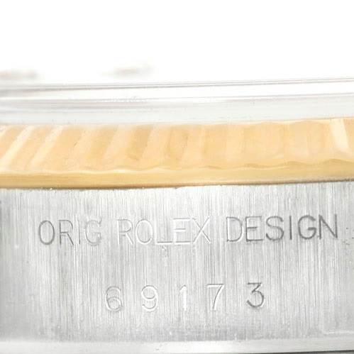 The image shows a close-up of the side of a Rolex Datejust 69173 Women's Stainless Steel Beige Dial 69173 Women's Stainless Steel Beige Dial watch, highlighting its case with the engraving "ORIG ROLEX DESIGN 69173."