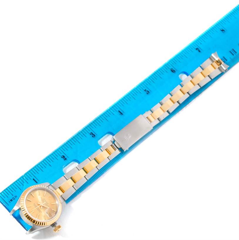 The image shows a Rolex Datejust 69173 Women's Stainless Steel Champagne Dial 69173 Women's Stainless Steel Champagne Dial watch, laid flat with the face, bracelet, and clasp next to a ruler for scale.