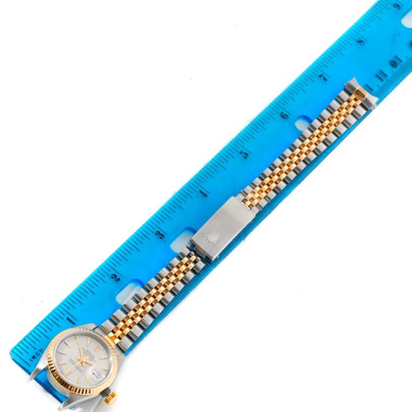 This image shows the Rolex Datejust 79173 Women's Stainless Steel Silver Dial 79173 Women's Stainless Steel Silver Dial watch positioned alongside a ruler, capturing its dial, bracelet, and clasp.