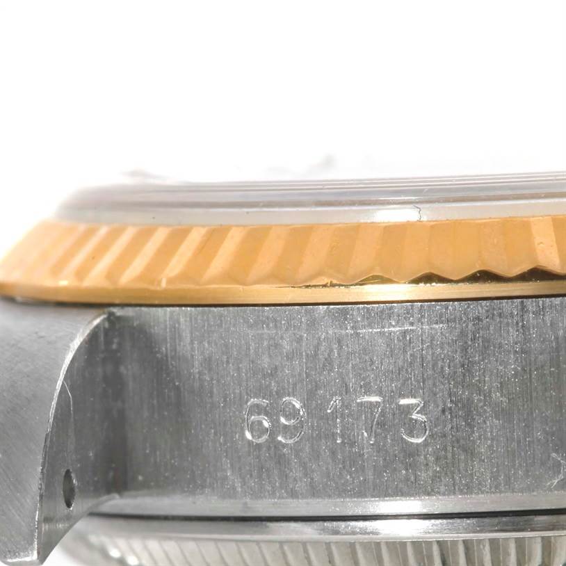 This image shows a close-up side view of the bezel, crystal, and case of a Rolex Datejust 69173 Women's Stainless Steel White Dial 69173 Women's Stainless Steel White Dial watch, including a model number.