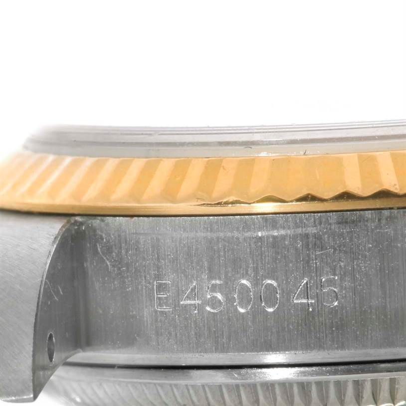 This close-up image shows the serial number and fluted bezel of a Rolex Datejust 69173 Women's Stainless Steel White Dial 69173 Women's Stainless Steel White Dial watch.
