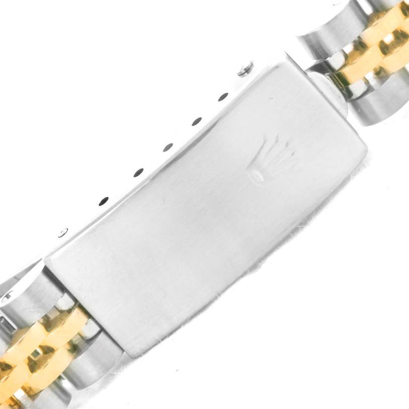 The image shows the clasp of a Rolex Datejust 69173 Women
s Stainless Steel Champagne Dial 69173 Women
s Stainless Steel Champagne Dial watch, highlighting the metal bracelet with gold accents.