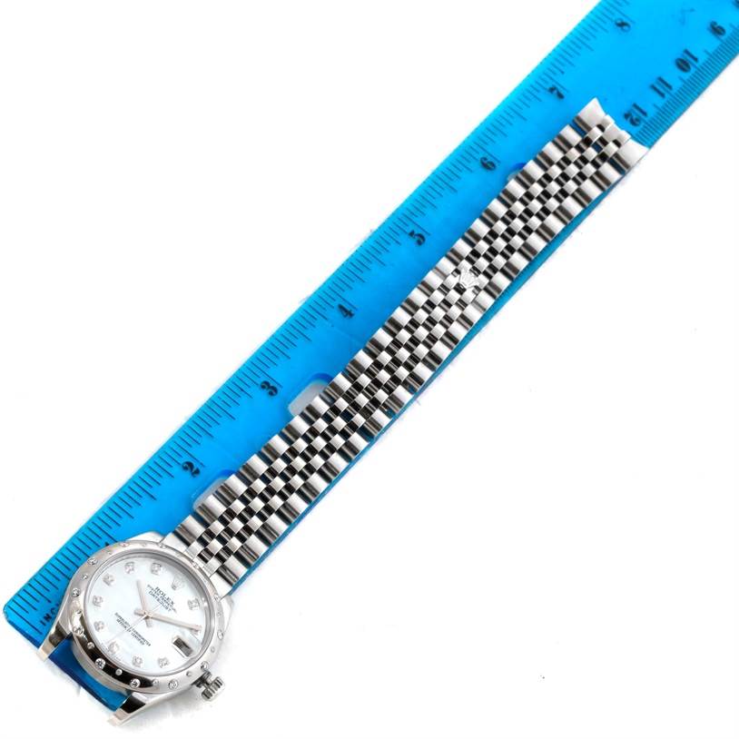 The image shows a Rolex Mid-Size 178344 Women's Stainless Steel Mother of Pearl Dial 178344 Women's Stainless Steel Mother of Pearl Dial model watch laid flat next to a blue ruler, displaying the face, bezel, and bracelet.