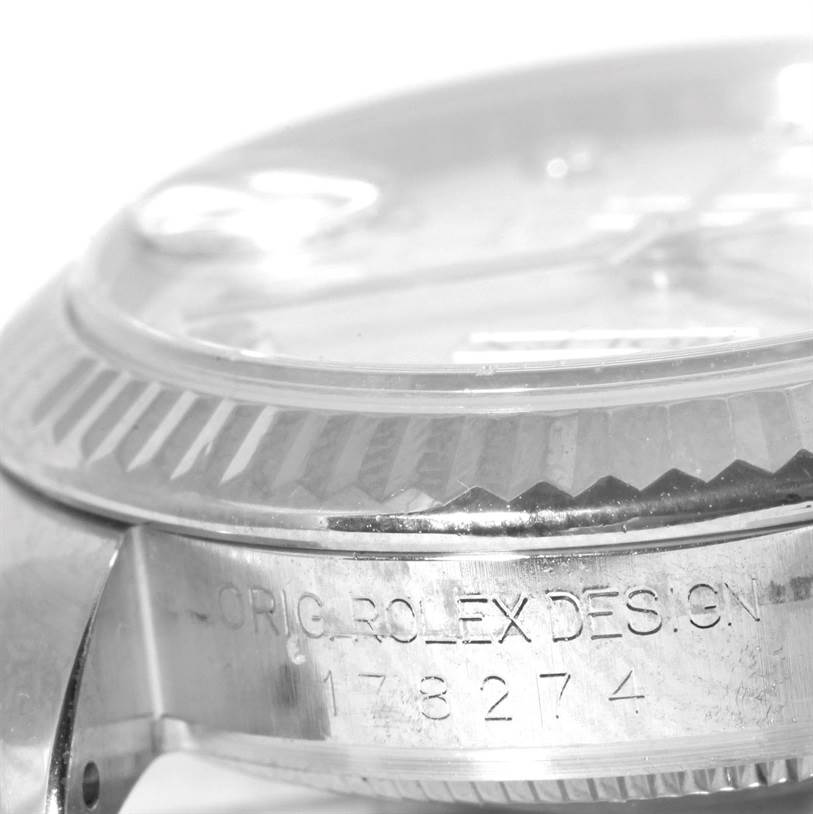 This side view of the Rolex Mid-Size 178274 Women
s Stainless Steel Silver Dial 178274 Women
s Stainless Steel Silver Dial model shows the engraved case side and the watch
s fluted bezel.