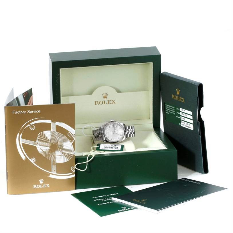 This image shows a mid-size Rolex watch with its box, warranty booklet, factory service booklet, and other accessories.