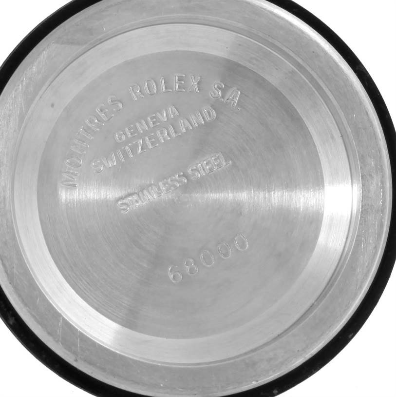 This image shows the back case of a mid-size Rolex watch, displaying engravings and the model number 68000.