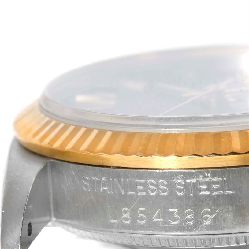 The image shows a close-up side view of a Mid-Size Rolex watch, displaying the stainless steel case and part of the bezel.