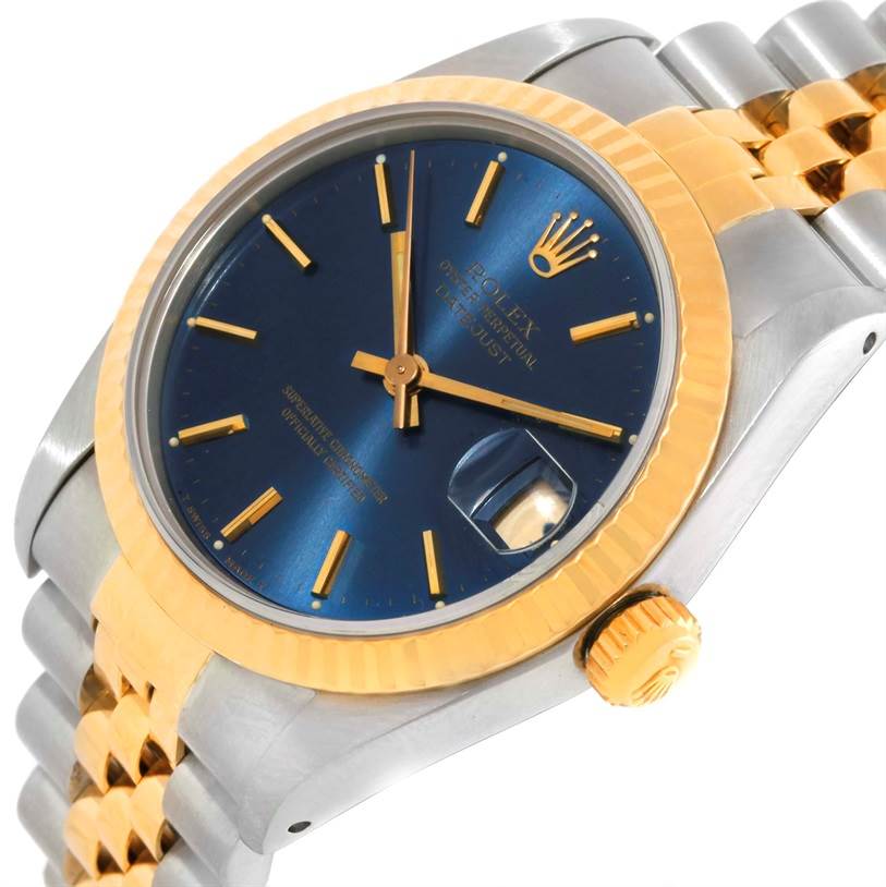 The image shows a close-up angled view of the face, crown, and part of the bracelet of a mid-size Rolex Datejust watch.