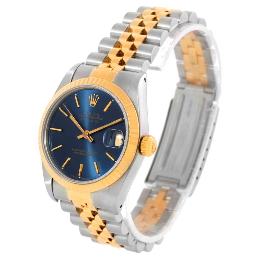 This image shows a Rolex Mid-Size 68273 Women's Steel and Gold (two tone) Blue Dial 68273 Women's Steel and Gold (two tone) Blue Dial model watch at a three-quarter angle, highlighting its blue dial, gold bezel, and two-tone bracelet.