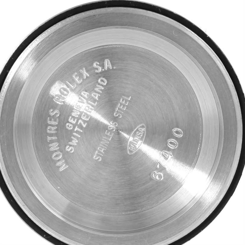The image shows the inner side of a Mid-Size Rolex watch back cover, engraved with details like "Rolex S.A.," "Geneva," "Switzerland," and "Stainless Steel".