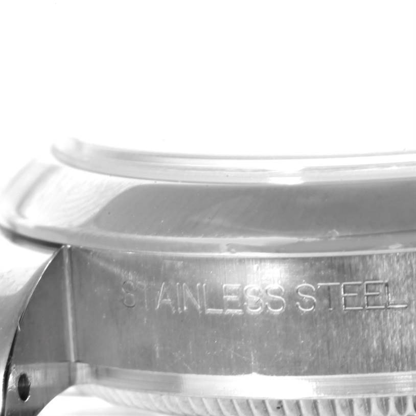 This image shows a close-up side view of the case back and part of the bezel of a Rolex Mid-Size 178240 Women's Stainless Steel Pink Dial 178240 Women's Stainless Steel Pink Dial stainless steel watch.