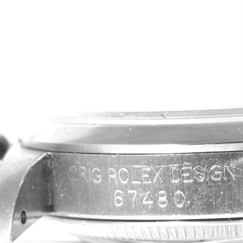 Close-up of the side casing of a Rolex Mid-Size 67480 Women's Stainless Steel Black Dial 67480 Women's Stainless Steel Black Dial watch, showing the model number 67480 and "ORIG ROLEX DESIGN" engraving.