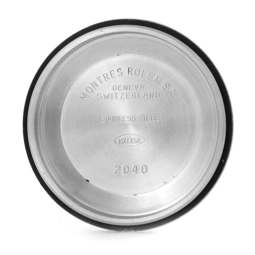 This image shows the inside of the case back of a Mid-Size Rolex watch, displaying the brand's inscriptions and serial number.