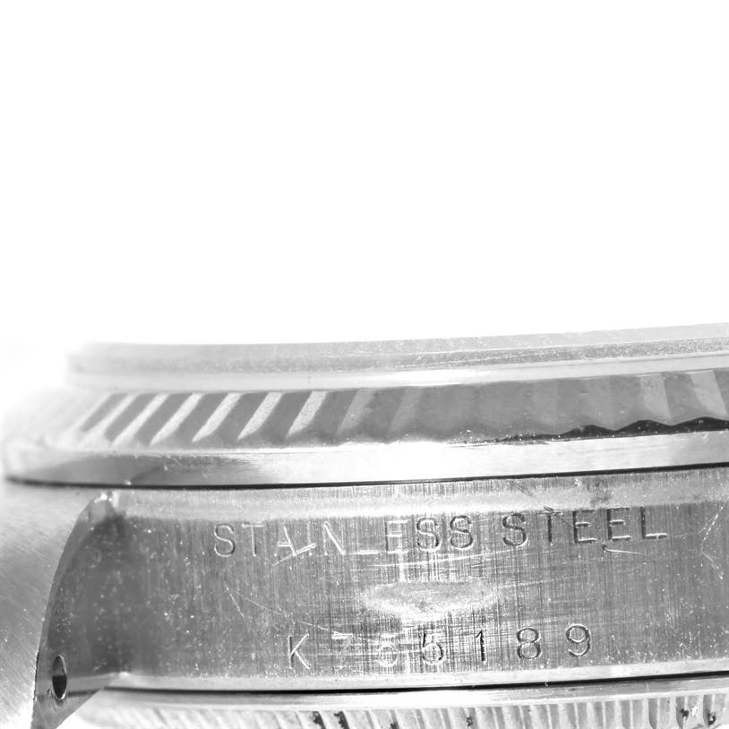 This image shows a close-up of the side of the Mid-Size Rolex watch, highlighting the stainless steel case with model engravings.