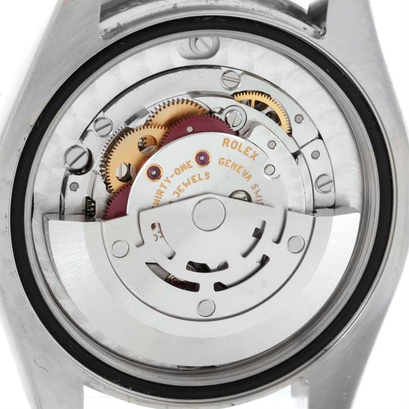 This image shows the movement parts of a Rolex Mid-Size 177200 Stainless Steel Silver Dial 177200 Stainless Steel Silver Dial model from a back view angle, highlighting gears and the rotor.