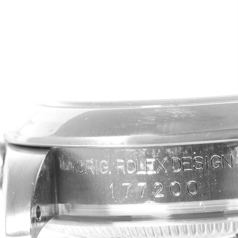 The image shows a close-up of the side casing with engraving on a Mid-Size Rolex watch.