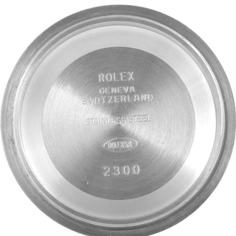 The image shows the inside case back of a mid-size Rolex watch, emphasizing the brand logo and material details from a top view.