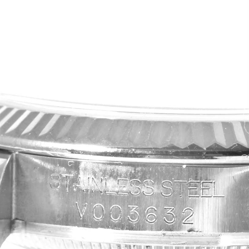 This image shows a close-up of the caseback and part of the fluted bezel of a Rolex Mid-Size 178274 Women's Stainless Steel Blue Dial 178274 Women's Stainless Steel Blue Dial model watch, highlighting its serial number.